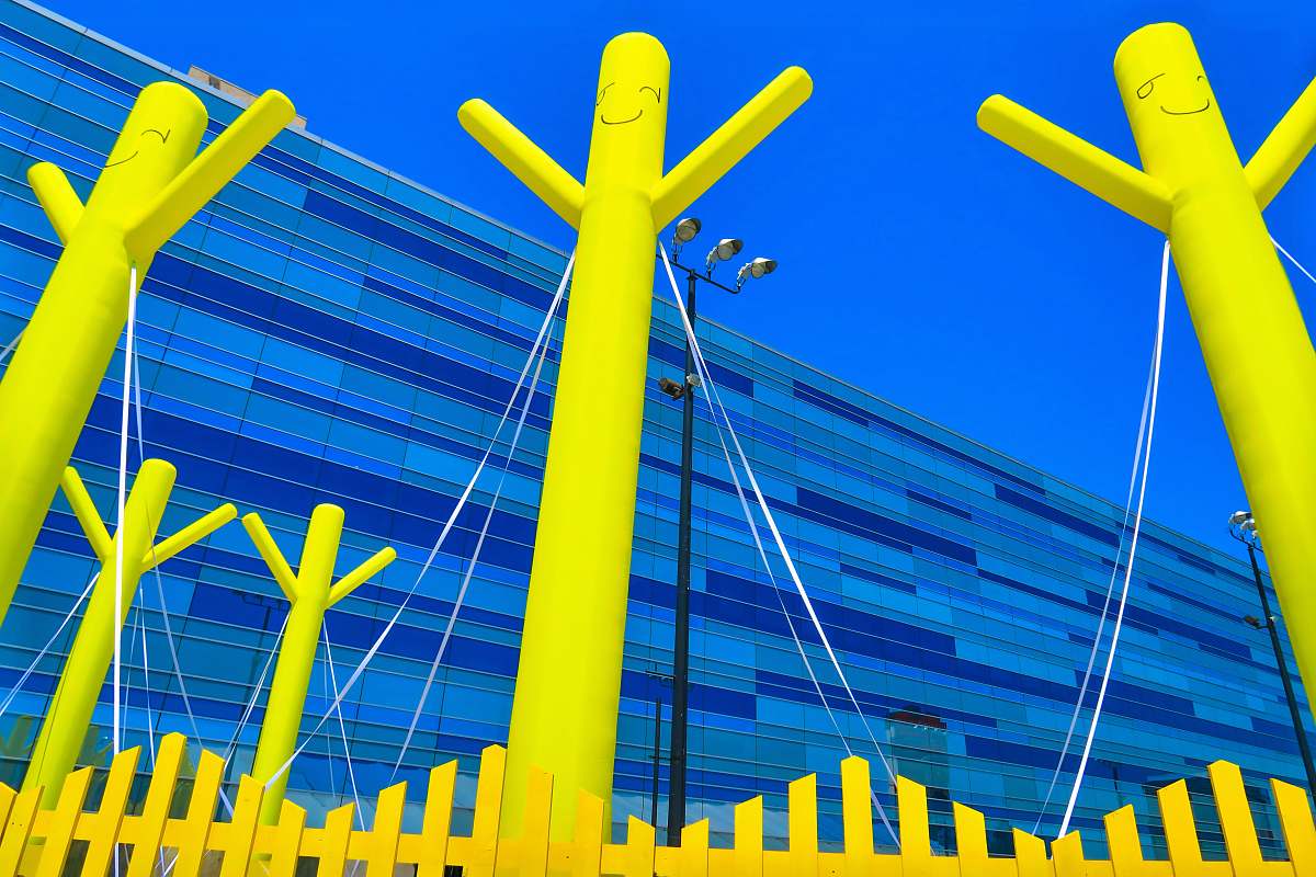 united states three yellow poles in back of yellow fence blue
